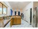 Spacious kitchen with wood cabinetry, neutral countertops, and white appliances, offering ample storage at 7915 N 53Rd Dr, Glendale, AZ 85301
