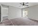Bedroom showcasing a ceiling fan, sliding glass door to the backyard, and neutral carpet at 860 N Mcqueen Rd # 1184, Chandler, AZ 85225