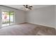 Spacious bedroom with a ceiling fan and sliding glass door to the backyard at 860 N Mcqueen Rd # 1184, Chandler, AZ 85225