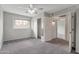Bright bedroom features a ceiling fan, closet, and a window overlooking the yard at 860 N Mcqueen Rd # 1184, Chandler, AZ 85225