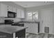 Modern kitchen with gray countertops, white cabinets, and stainless steel appliances at 860 N Mcqueen Rd # 1184, Chandler, AZ 85225