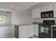 Well-equipped kitchen with white cabinets, island, and stainless steel appliances at 860 N Mcqueen Rd # 1184, Chandler, AZ 85225