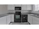 Well-lit kitchen features modern appliances, white cabinetry, and gray countertops, complemented by wood-look flooring at 860 N Mcqueen Rd # 1184, Chandler, AZ 85225