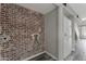 Laundry room featuring a brick wall design and connections for a washer and dryer at 860 N Mcqueen Rd # 1184, Chandler, AZ 85225