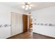 Charming bedroom featuring hardwood floors, floral wallpaper, ceiling fan and access to the bathroom at 8629 E Cambridge Ave, Scottsdale, AZ 85257