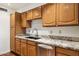 Well-maintained kitchen features granite countertops, wood cabinets, stainless steel dishwasher, and double bowl sink at 8629 E Cambridge Ave, Scottsdale, AZ 85257