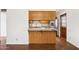 Kitchen featuring a breakfast bar with granite countertops, wooden cabinets, and stainless steel appliances at 8629 E Cambridge Ave, Scottsdale, AZ 85257