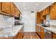 Bright kitchen featuring granite countertops, wooden cabinets, stainless steel appliances and wood flooring at 8629 E Cambridge Ave, Scottsdale, AZ 85257