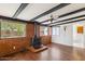View of living room showcasing a fireplace with brick surround, exposed beams, and hardwood flooring at 8629 E Cambridge Ave, Scottsdale, AZ 85257