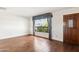 Bright living room with hardwood floors, large window providing natural light, and a welcoming front door at 8629 E Cambridge Ave, Scottsdale, AZ 85257