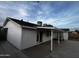 Rear exterior view of home with full-length covered patio, perfect for outdoor entertaining and relaxation at 8719 W Monterey Way, Phoenix, AZ 85037