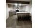 Modern kitchen with gray cabinets, stainless steel appliances, and a breakfast bar with seating for casual dining at 8719 W Monterey Way, Phoenix, AZ 85037