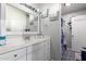 Bathroom featuring a vanity with storage and countertop space, a large mirror, and stylish lighting at 8741 W Manzanita Dr, Peoria, AZ 85345