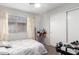 Cozy bedroom featuring a window, closet, ceiling fan and table with decorative flower arrangement at 8741 W Manzanita Dr, Peoria, AZ 85345