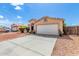 Cozy single-story house with a well-manicured front yard and long driveway leading to a two-car garage at 8741 W Manzanita Dr, Peoria, AZ 85345