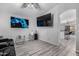Bright living room featuring modern flooring, neutral walls, and contemporary decor with a large TV at 8741 W Manzanita Dr, Peoria, AZ 85345