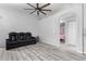 Bright living room with wood-look tile floors, simple decor, and lots of natural light, creating an open and inviting space at 8741 W Manzanita Dr, Peoria, AZ 85345
