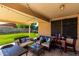 Inviting covered patio featuring comfortable seating and a backyard view at 8741 W Manzanita Dr, Peoria, AZ 85345