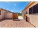 Side yard featuring gravel landscaping and a wood gate, providing easy access to the backyard at 8741 W Manzanita Dr, Peoria, AZ 85345