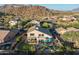 Aerial view of backyard featuring a covered patio, pool, lush landscaping, and privacy walls at 9443 E Mallory St, Mesa, AZ 85207