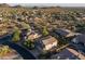 Stunning aerial view of a suburban neighborhood with desert landscaping, mountains, and beautiful homes at 9443 E Mallory St, Mesa, AZ 85207