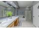 Bathroom featuring a double vanity, soaking tub, and a separate shower with glass door at 9443 E Mallory St, Mesa, AZ 85207
