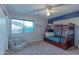 A bedroom with a wooden bunkbed, carpet, and a window with views of the mountains at 9443 E Mallory St, Mesa, AZ 85207