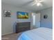 Spacious bedroom has a dresser with a TV, carpet, and a sliding-door closet at 9443 E Mallory St, Mesa, AZ 85207
