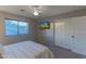 Bright bedroom featuring a queen bed, carpeting, sliding closet doors, and a window with mountain views at 9443 E Mallory St, Mesa, AZ 85207
