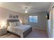 Serene bedroom features a queen bed, carpeting, and a mounted television on the wall at 9443 E Mallory St, Mesa, AZ 85207
