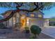 Charming two-story home with desert landscaping and a welcoming entrance framed by a large, picturesque tree at 9443 E Mallory St, Mesa, AZ 85207