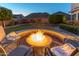 Cozy backyard fire pit surrounded by comfortable seating, perfect for outdoor gatherings at 9443 E Mallory St, Mesa, AZ 85207