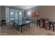 This game room has a ping pong table and wet bar area illuminated by natural light from a bay window at 9443 E Mallory St, Mesa, AZ 85207
