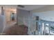 Upstairs hallway featuring a white railing overlooking the first floor and neutral carpeting at 9443 E Mallory St, Mesa, AZ 85207