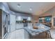 Bright kitchen features an island with granite countertops, white cabinetry, and stainless steel appliances at 9443 E Mallory St, Mesa, AZ 85207