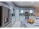 This kitchen features stainless steel appliances, granite countertops, and ample cabinet space at 9443 E Mallory St, Mesa, AZ 85207