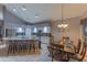 Eat-in kitchen and dining area featuring a granite countertop island with stool seating and updated appliances at 9443 E Mallory St, Mesa, AZ 85207