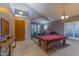 Spacious living room features a pool table, ping pong table, and stylish furnishings, ideal for entertaining at 9443 E Mallory St, Mesa, AZ 85207