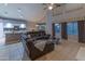 Spacious living room area next to the kitchen boasts a comfortable sectional and access to a pool at 9443 E Mallory St, Mesa, AZ 85207
