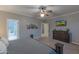 Main bedroom showcasing neutral tones, a ceiling fan, artwork, and a full bathroom at 9443 E Mallory St, Mesa, AZ 85207