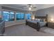 Spacious main bedroom with large windows and a stylish bedroom set with views of the backyard at 9443 E Mallory St, Mesa, AZ 85207