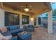 Relaxing covered patio featuring comfortable seating, ceiling fan, and serene outdoor ambiance at 9443 E Mallory St, Mesa, AZ 85207