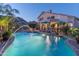 Backyard view of a sparkling pool, fountains, lounge chairs, and manicured landscaping at 9443 E Mallory St, Mesa, AZ 85207
