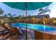 Relaxing pool with sun loungers and lush, verdant landscaping at 9443 E Mallory St, Mesa, AZ 85207