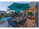 Resort-style backyard with a sparkling pool, lounge chairs, patio seating, and lush landscaping at 9443 E Mallory St, Mesa, AZ 85207