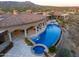 Aerial view showcases the pool, spa, covered patio, and lush desert landscape at 9643 E Legacy Ridge Rd, Scottsdale, AZ 85262