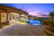 Luxurious backyard with an infinity pool, spa, outdoor kitchen and stunning sunset views at 9643 E Legacy Ridge Rd, Scottsdale, AZ 85262