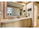 A bathroom featuring double sinks with decorative mirrors and tiled countertops for a touch of elegance at 9643 E Legacy Ridge Rd, Scottsdale, AZ 85262