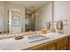 Classic bathroom vanity with tiled backsplash, spacious countertop, and warm, inviting lighting at 9643 E Legacy Ridge Rd, Scottsdale, AZ 85262