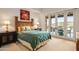 Comfortable bedroom with a detailed headboard, outdoor access, and warm natural light for a relaxing atmosphere at 9643 E Legacy Ridge Rd, Scottsdale, AZ 85262